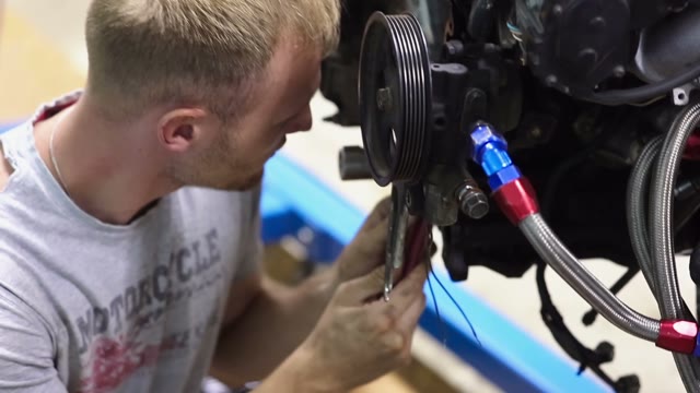 Attentive Mechanic Inspect The Car Engine