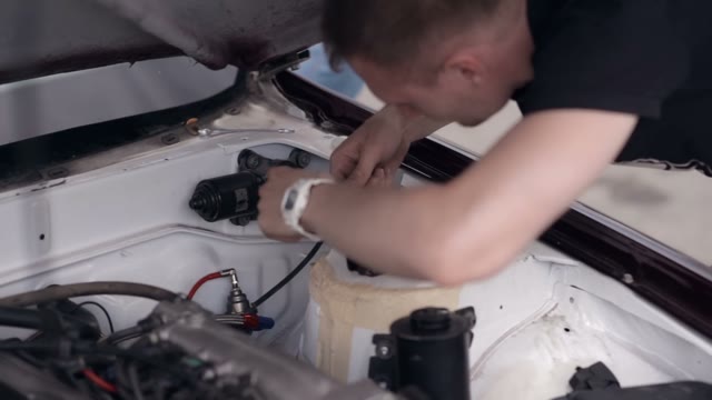 Young Guy Checks The Engine Of His Car