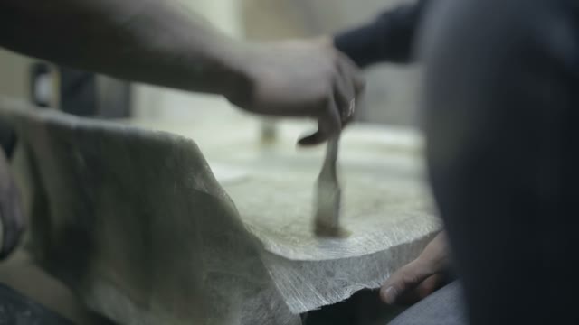Workers Apply Varnish