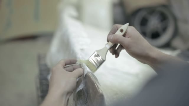 Painter Put Varnish On The Surface Of The Item