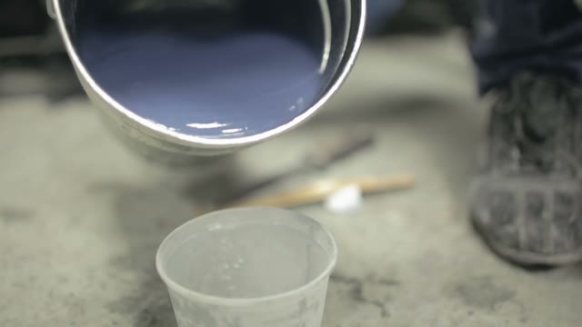 The Varnish Poured From A Bucket Into The Glass