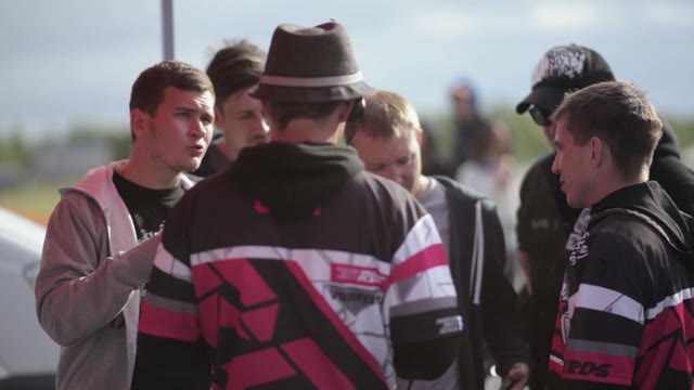 Group Of Men Discussing Something With The Racing Judges
