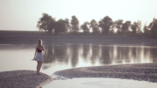 Young Beautiful Blonde Walks By The River