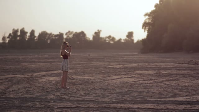 Young Beautiful Blonde Walks By The River