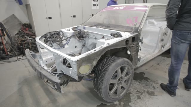 Workers Prepare The Car For Painting