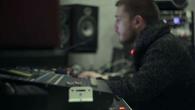 A Young Sound Engineer At Work In The Studio