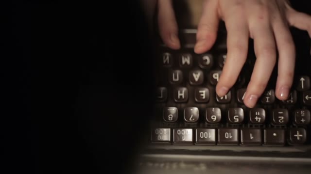 Girl Typing On An Old Typewriter