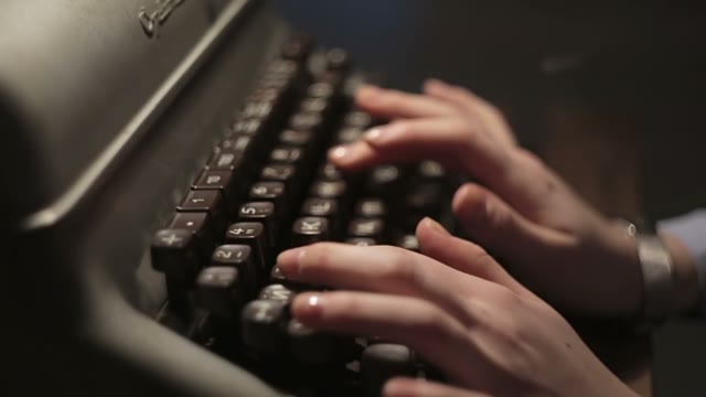 Girl Typing On An Old Typewriter