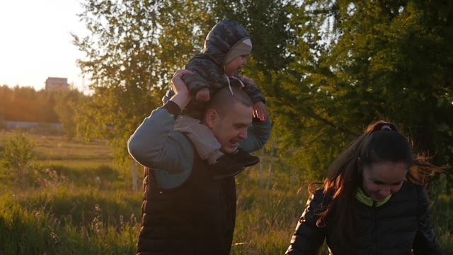 Family Playing With Baby On Sunset