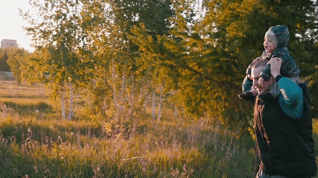 Family Playing With A Baby In Nature