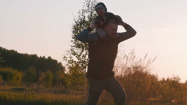 Happy Father Playing With Baby