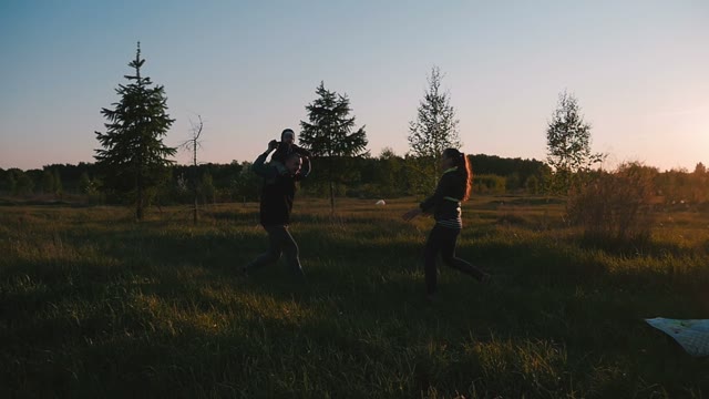 Happy Family Playing With A Baby In Nature