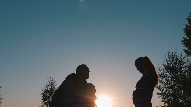 Father Plays And Throws The Baby At Sunset