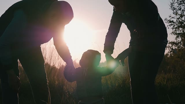 Happy Couple Playing With A Small Child On The Nature
