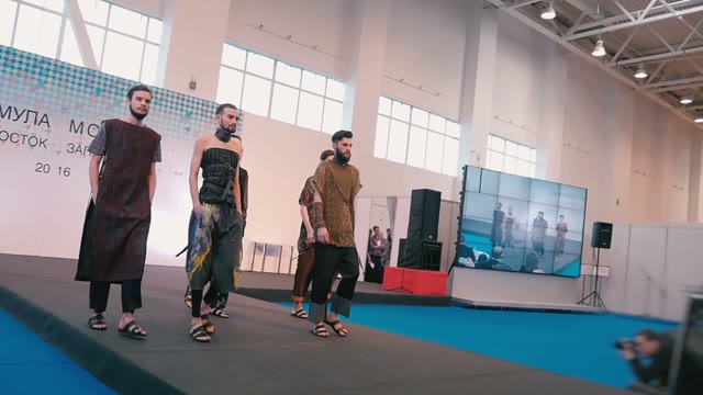 Fashion Show. Male Model In The Dresses Go On The Catwalk