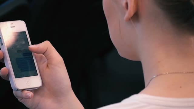A Woman Looking In The Phone