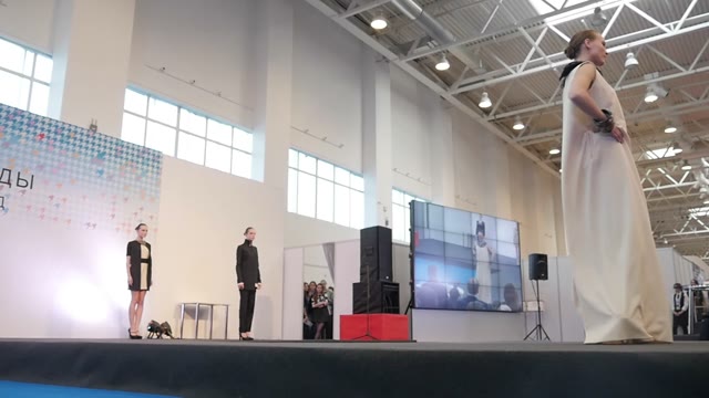 Fashion Show. Female Models In Dresses Go On The Catwalk