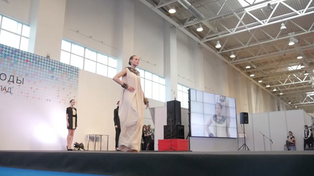 Fashion Show. Female Models In Dresses Go On The Catwalk