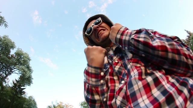 Young Man In Sunglasses Posing At The Camera