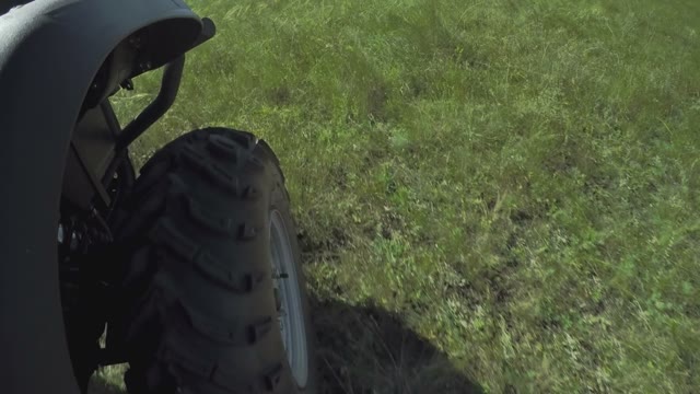 Quad Bike Rides On The Field, Close-up Of Wheel
