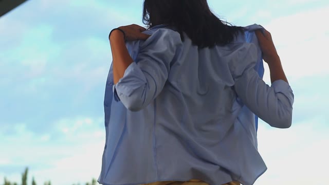 Woman Takes Off Her Blouse In Front Of Camera