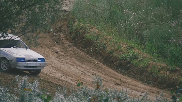 Two Rally Cars Passing On The Sandy Track