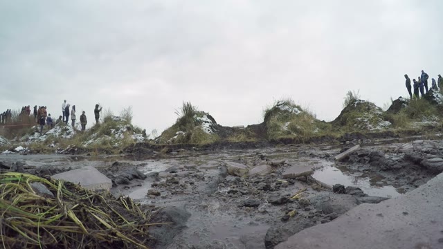 Off-road Car Driving On A Dirt Road And Passes Through A Puddle