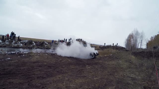 Off-road Car Driving On A Dirt Road And Smokes