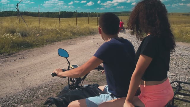 Young Guy And The Girl Riding On ATV