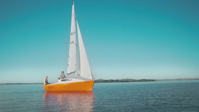 Young People Traveling On A Small Sailing Boat