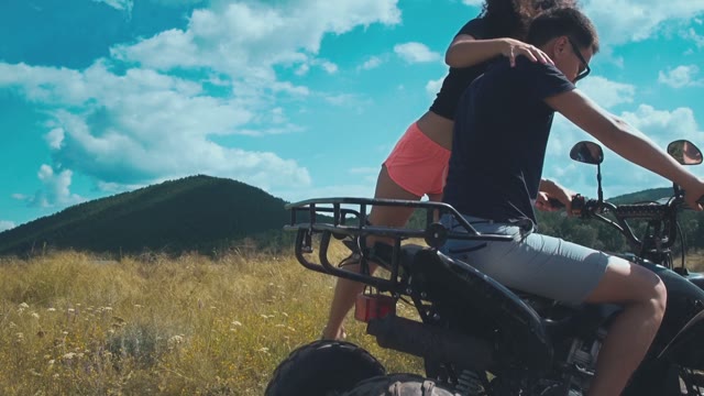 Beautiful Girl Sit On The ATV To A Guy