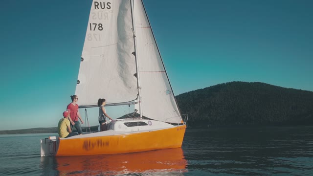 Young People Traveling On A Small Sailing Boat