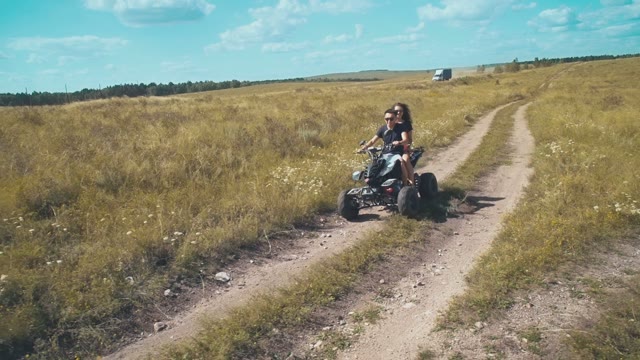 Young Guy And The Girl Riding On ATV
