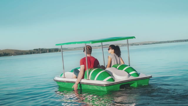 Young Couple Walk On A Catamaran