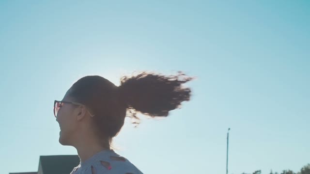 Beautiful Young Girl In Sunglasses Talking On The Field. Sunlight Glare And