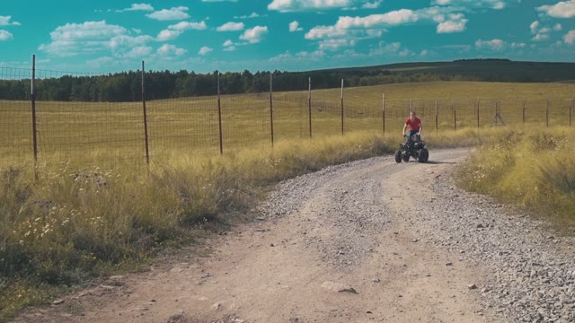 Brave Young Man Rides A An ATV On A Field