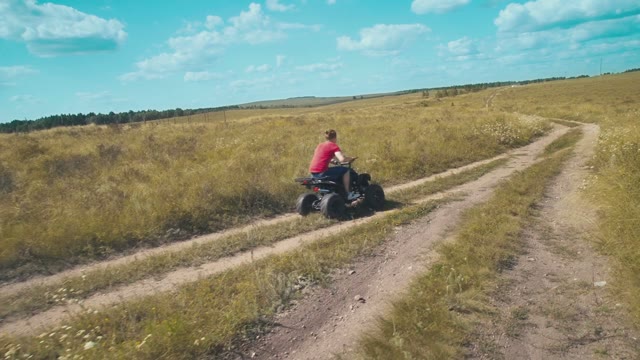 A Brave Guy Goes Fast On An ATV On The Field