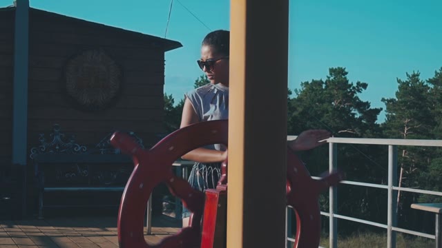 Young Girl In Sunglasses Spinning Control Wheel