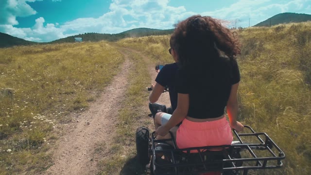 Man Goes With His Girlfriend On An ATV On The Field
