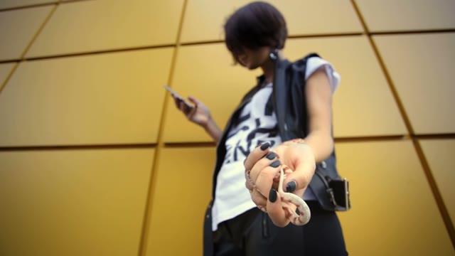 Charming Young Girl Using Telephone Holding Snakes In Her Hand