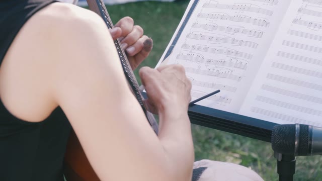 Woman Playing A Little Guitar