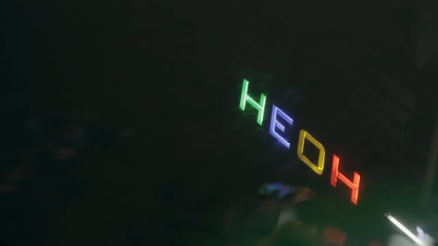 Neon Sign In The Reflection In A Puddle