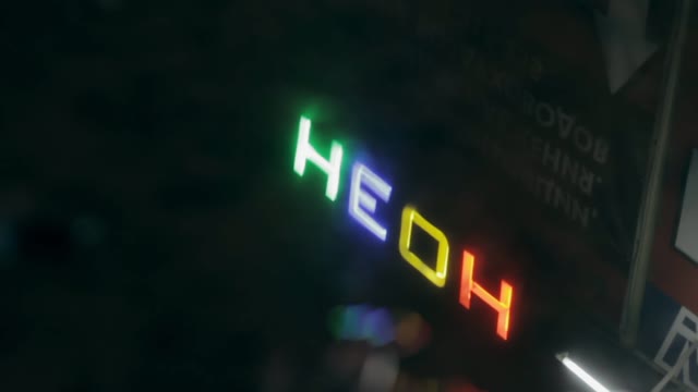 Neon Sign In The Reflection In A Puddle