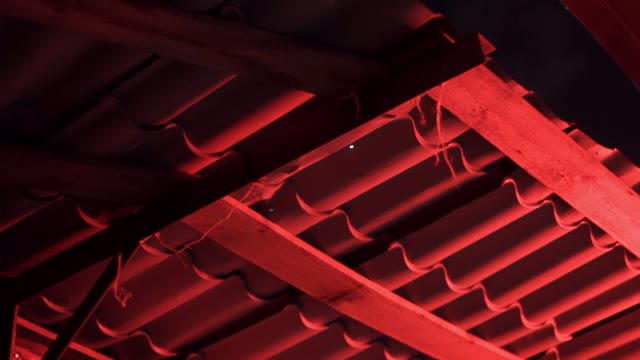 Blinking Red Light In The Darkness In Urban Slums