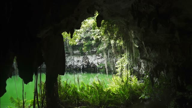 The Camera Shoots From The Cave A Small Pond