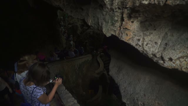 Many People Go Down The Stairs Into A Cave