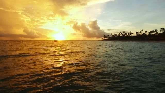The Camera Flies At Sunset On Blue Sea