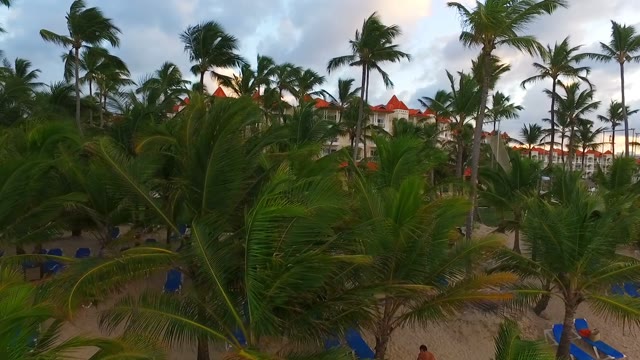 Drone Rises From The Sandy Beach And Approaches The Large Hotel