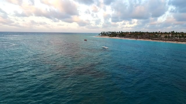The Camera Flies Over The Sea Along The Beach