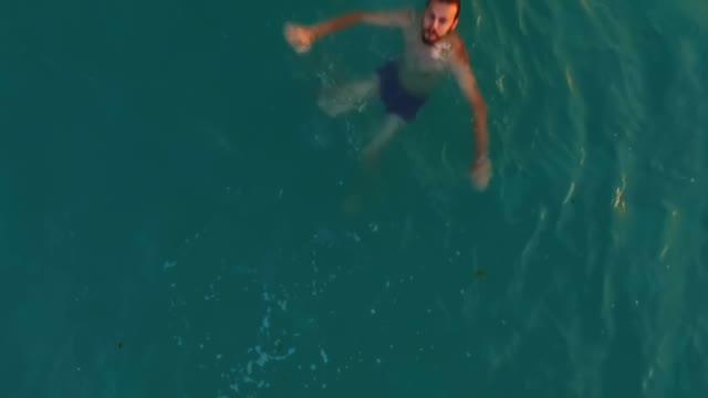Young Man Swims Sea